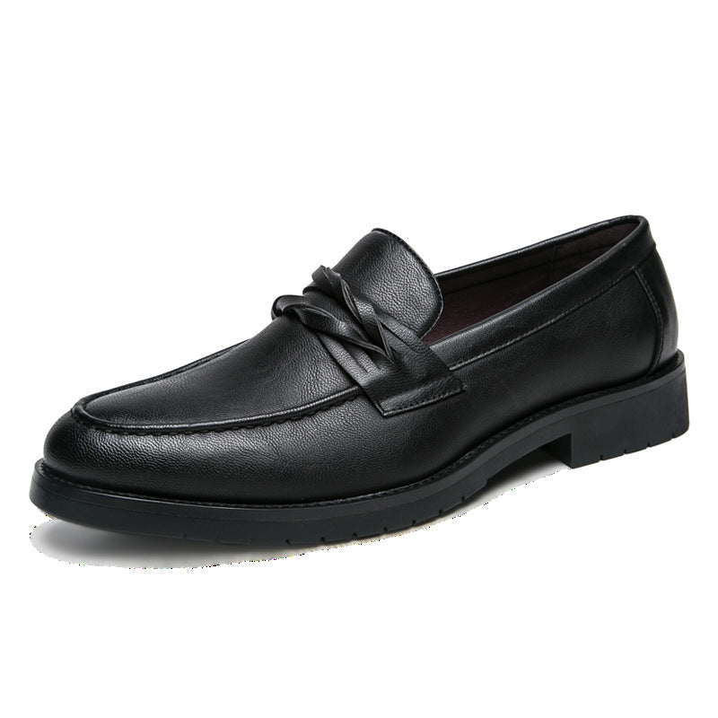 Single black slip-on loafer on white, braided saddle strap, burgundy lining and lugged rubber outsole