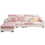 Pink and ecru herringbone jacquard stretch covers fitted over a sectional sofa front view