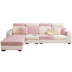 Pink and ecru herringbone jacquard stretch covers fitted over a sectional sofa front view