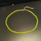 Faceted glass bead choker shown worn close around the neckline
