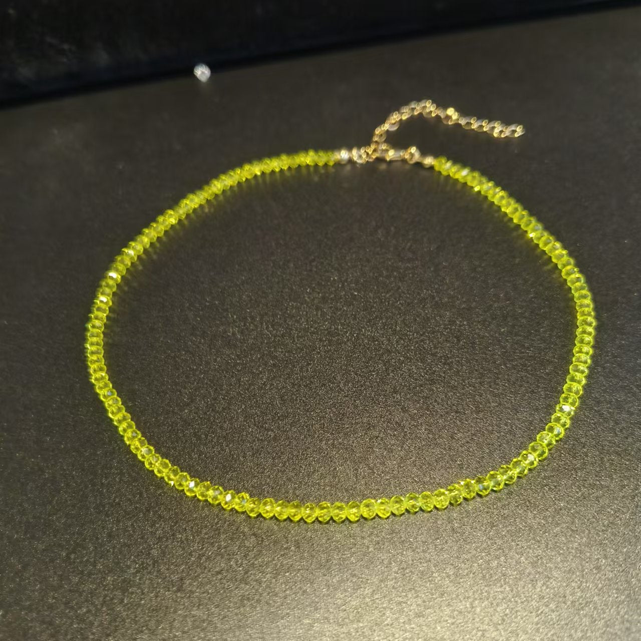Faceted glass bead choker shown worn close around the neckline