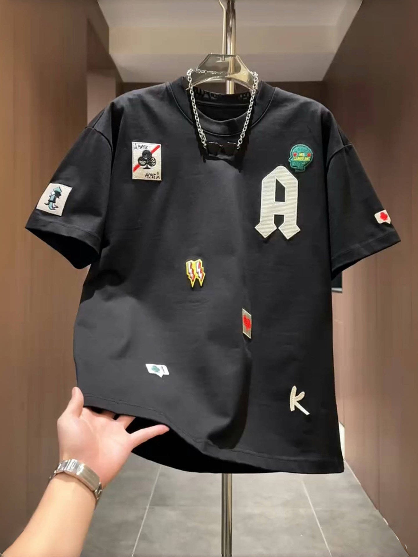 Men's loose fit embroidered patch T-shirt in black with a varsity A letter and sewn on patches