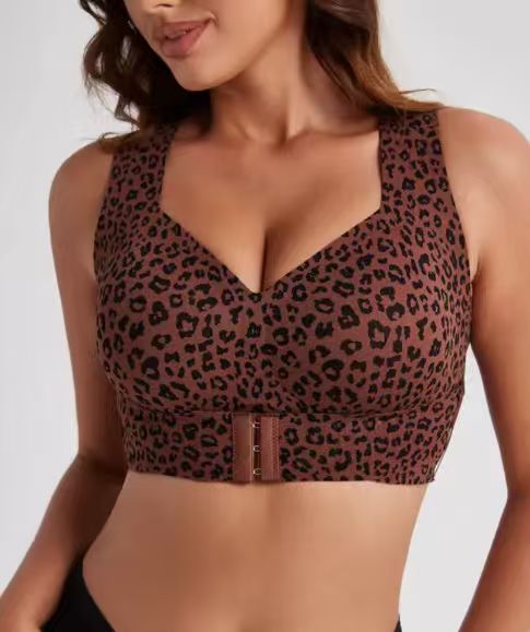 Support bra front closure being hooked at the centre by the model