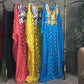 Pink, yellow and blue guipure lace kaftans hanging side by side