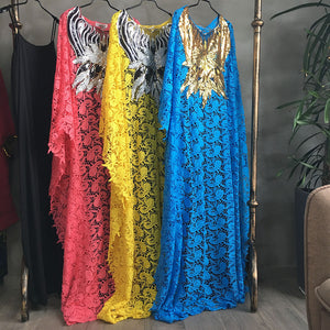Pink, yellow and blue guipure lace kaftans hanging side by side