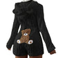 Back view of the black plush hooded romper with bear ears and a brown teddy bear patch on a plain background