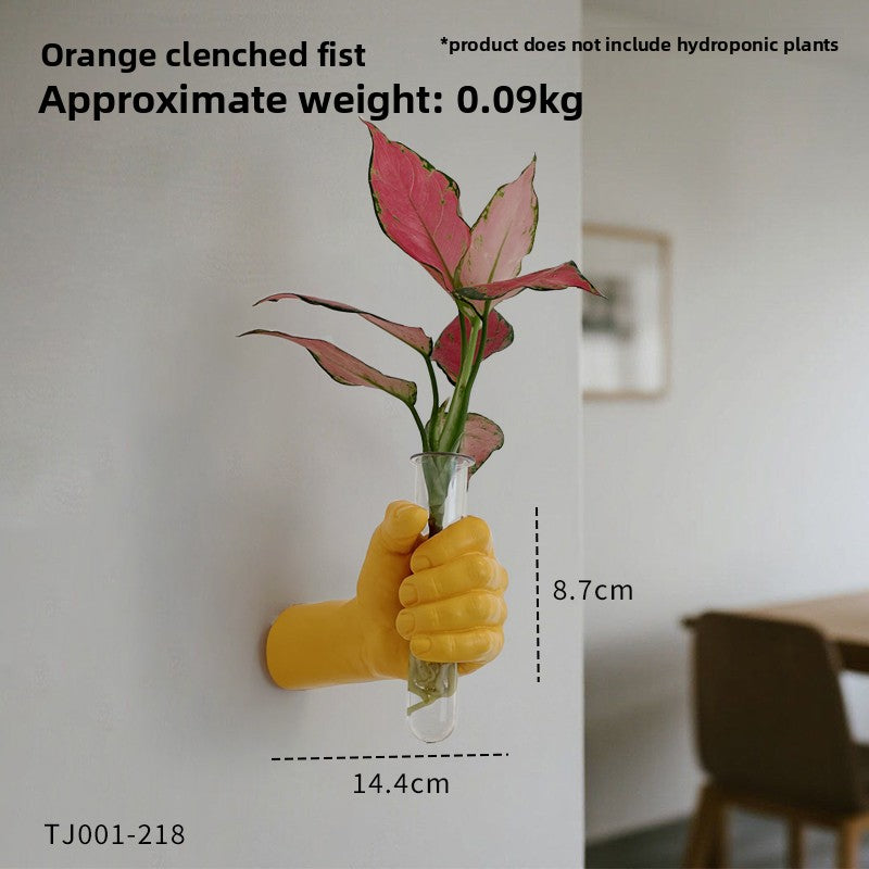 Hand shaped wall vase and its clear glass test tube shown as a two piece set