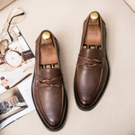 Brown recycled leather apron toe loafers seen from above on beige fabric, braided strap and wooden shoe trees