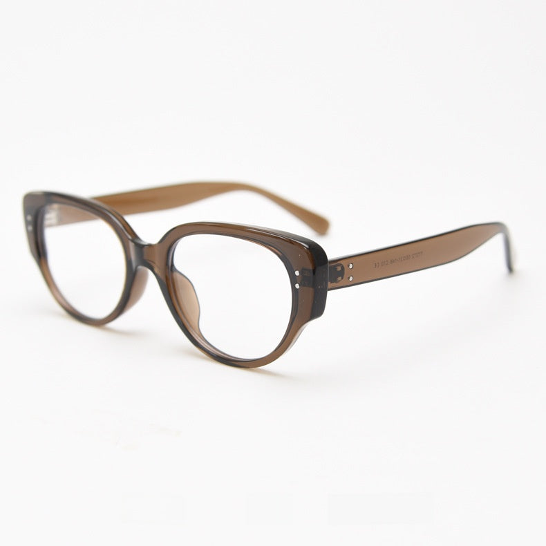 Translucent brown oval cat eye frame with clear lenses at an angle