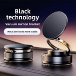 Black magnetic car phone holder with a round pad and knurled vacuum suction base on a dashboard