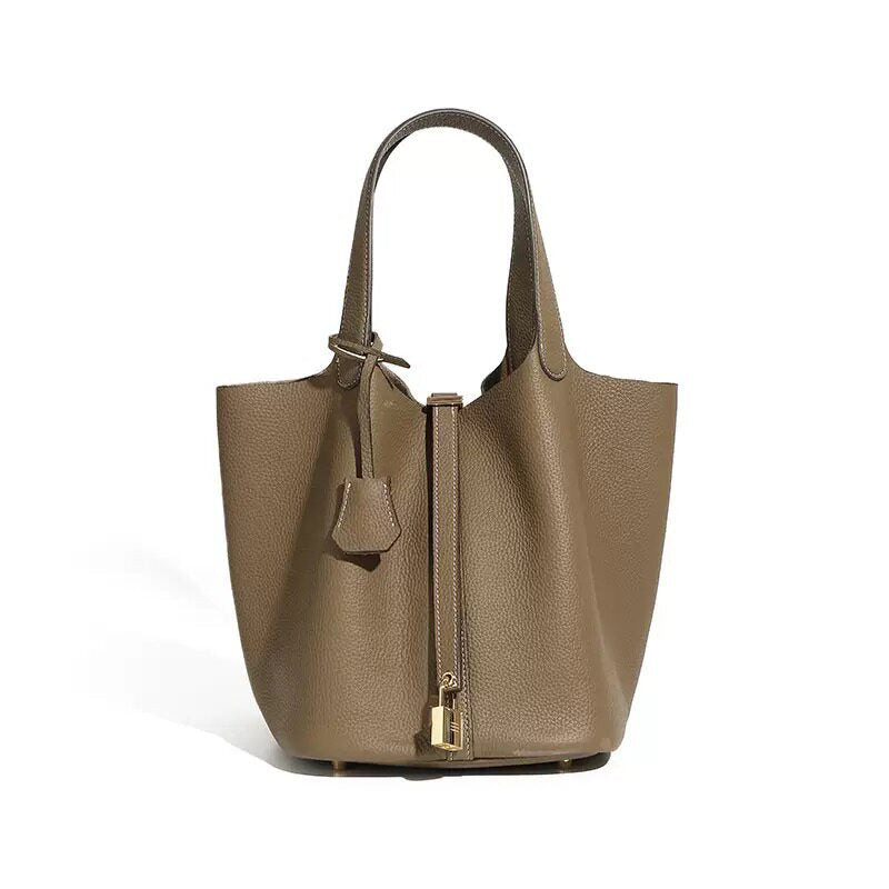 Leather bucket tote bag shown from a third angle on the strap