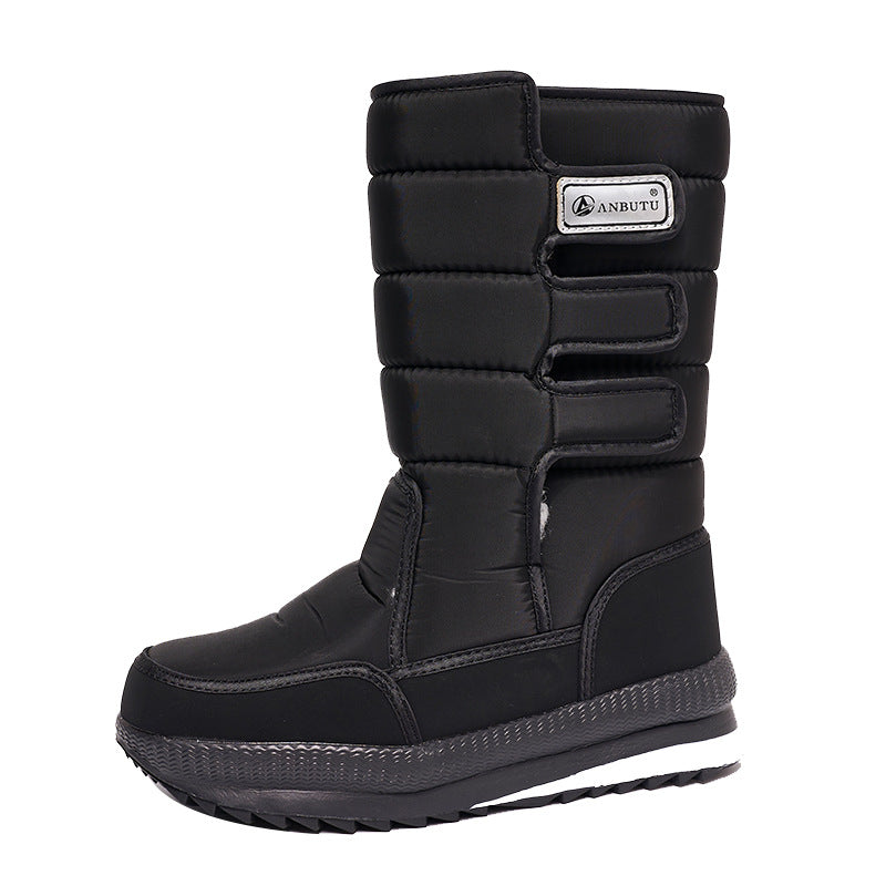 Winter snow boot with velcro front straps and a chunky lugged rubber sole, side view