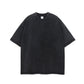 Washed black heavyweight cotton t-shirt with round neck and dropped shoulders laid flat on white