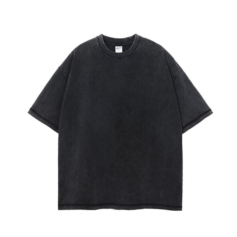 Washed black heavyweight cotton t-shirt with round neck and dropped shoulders laid flat on white
