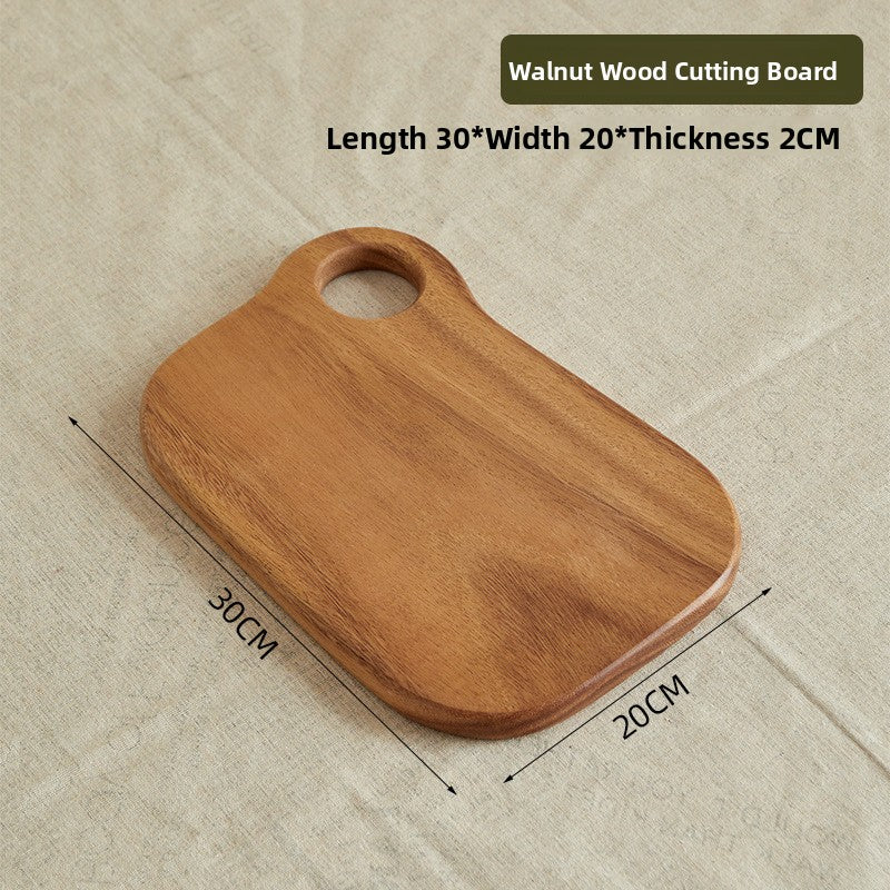 Walnut drumstick shaped board 40 by 20 cm with a long handle on a counter