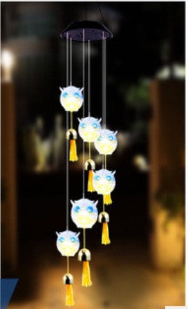 White owl LED figures with blue eyes and golden bells, hanging from a solar lamp head, red housing option
