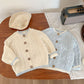 Knitted suspender baby pants showing the adjustable shoulder straps