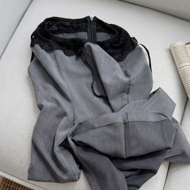 Folded gray wide-leg pants showing black lace waist and back zip detail