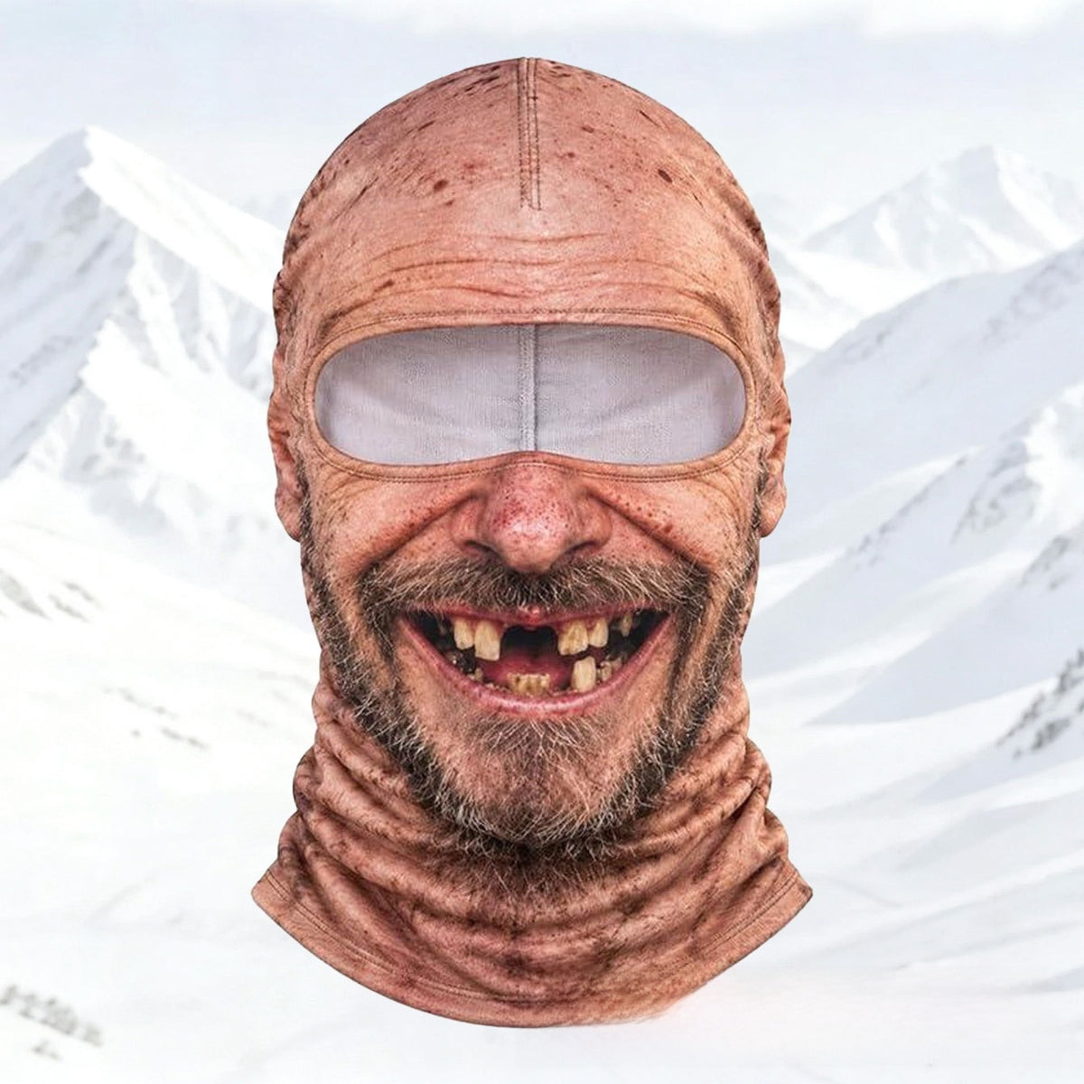 Printed elder face balaclava Elder1 with stubble beard and gap-toothed grin against a snowy mountain backdrop