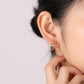 Close-up of the faceted zirconium stone set in the gold nail stud head