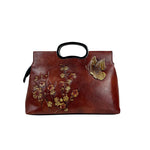 Brown embossed leather top handle handbag with plum blossom relief and metal butterfly