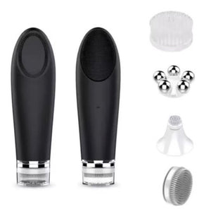 Ultrasonic facial cleanser held against a wet cheek in soft light
