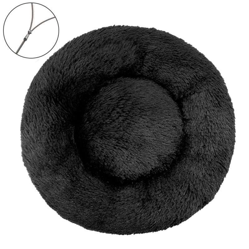Black round plush pet bed with a raised bolster rim on a plain background