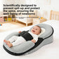 Smiling baby on a grey wedge lounger pillow with a black panel and strap, with a text overlay in the corner