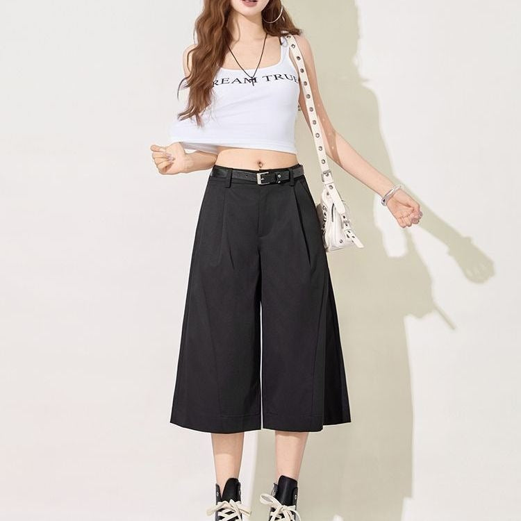 Detail of ice silk fabric drape on black cropped wide leg pants