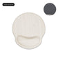 Memory foam wrist rest mouse pad next to a keyboard on a desk