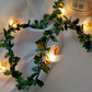 Bee LED fairy string light on a green leaf vine with a warm glow, decorative photo