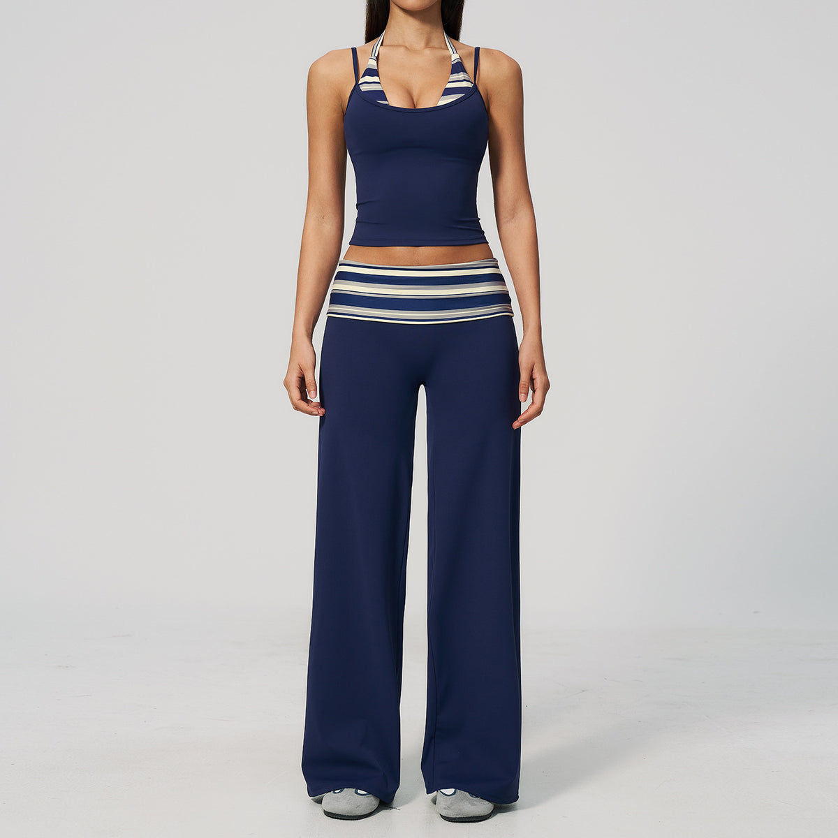 Model in a cropped camisole and wide leg fold over waist pants set, navy with cream and gray stripes