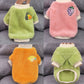 Four plush pet sweaters laid flat in green, pink, orange and green, front, back and neck opening views