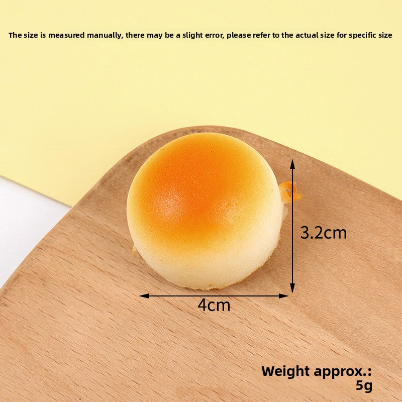 Keychain version of the squishy bread toy with a metal clip attached