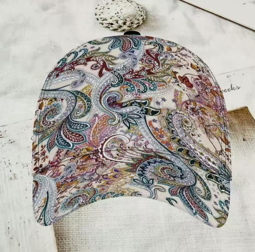 Colourful floral print cap laid flat to reveal the curved shading peak
