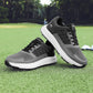 Pair of mens golf shoes photographed on green grass beside a golf club
