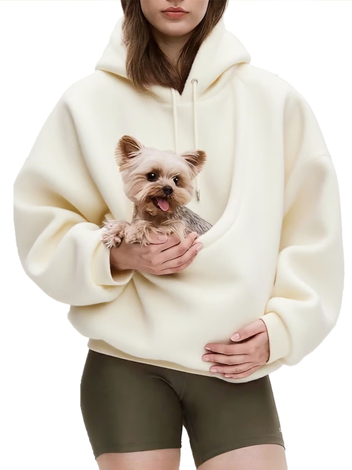 Model holding a small dog inside the pouch of the pink plush fleece hoodie
