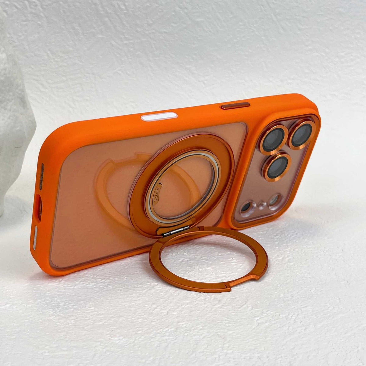 Orange phone case propped in landscape position on its folded-out ring stand