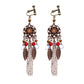 Bohemian vintage clip-on tassel drop earrings on a zinc alloy frame, handmade boho pair on white studio background