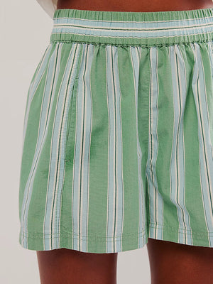 Green striped cotton pull on shorts on woman with smocked waistband