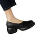 Black PU slip-on pump with chunky heel and platform sole worn with dark jeans on a white background