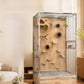 Parrot cage with a wooden back panel, clear glass front, side bowl door and two drawers, shown with perches and toys