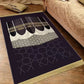 Plush velvet Islamic prayer mat with a printed ornamental design and fringed ends on a wood floor