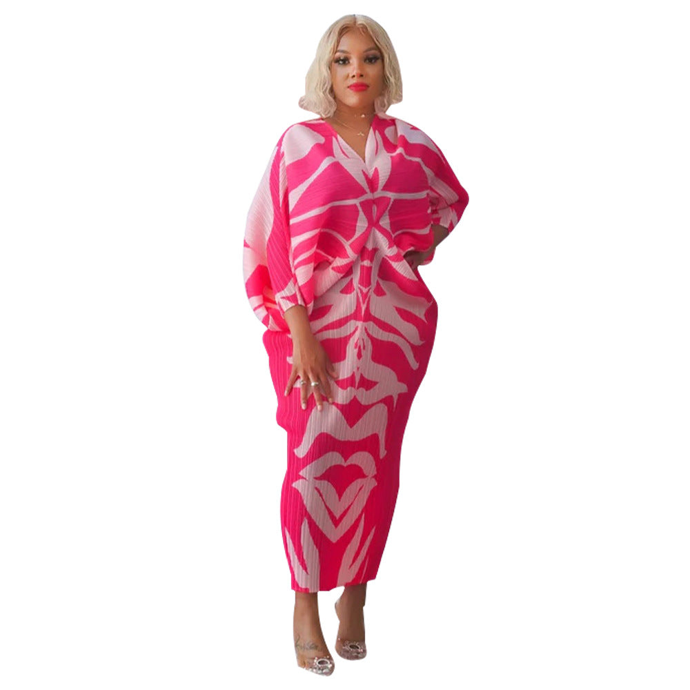 Pleated batwing V neck abstract print midi dress on a standing model, front view