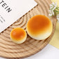Close up of the golden bun squishy showing its painted glossy crust finish