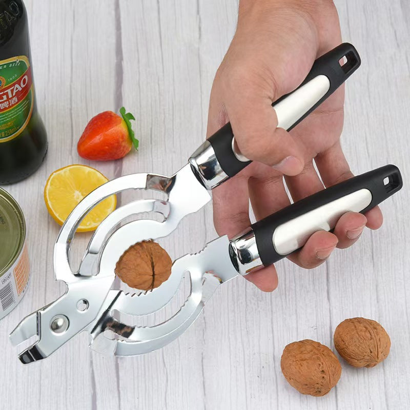 Hand holding the stainless multi opener beside a beer bottle, jar, lemon and walnuts