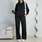 Black fleece hooded sweatshirt and wide-leg sweatpants set worn by a model
