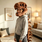 Brown plush dinosaur skeleton head mask worn from the side, spine hanging down the back