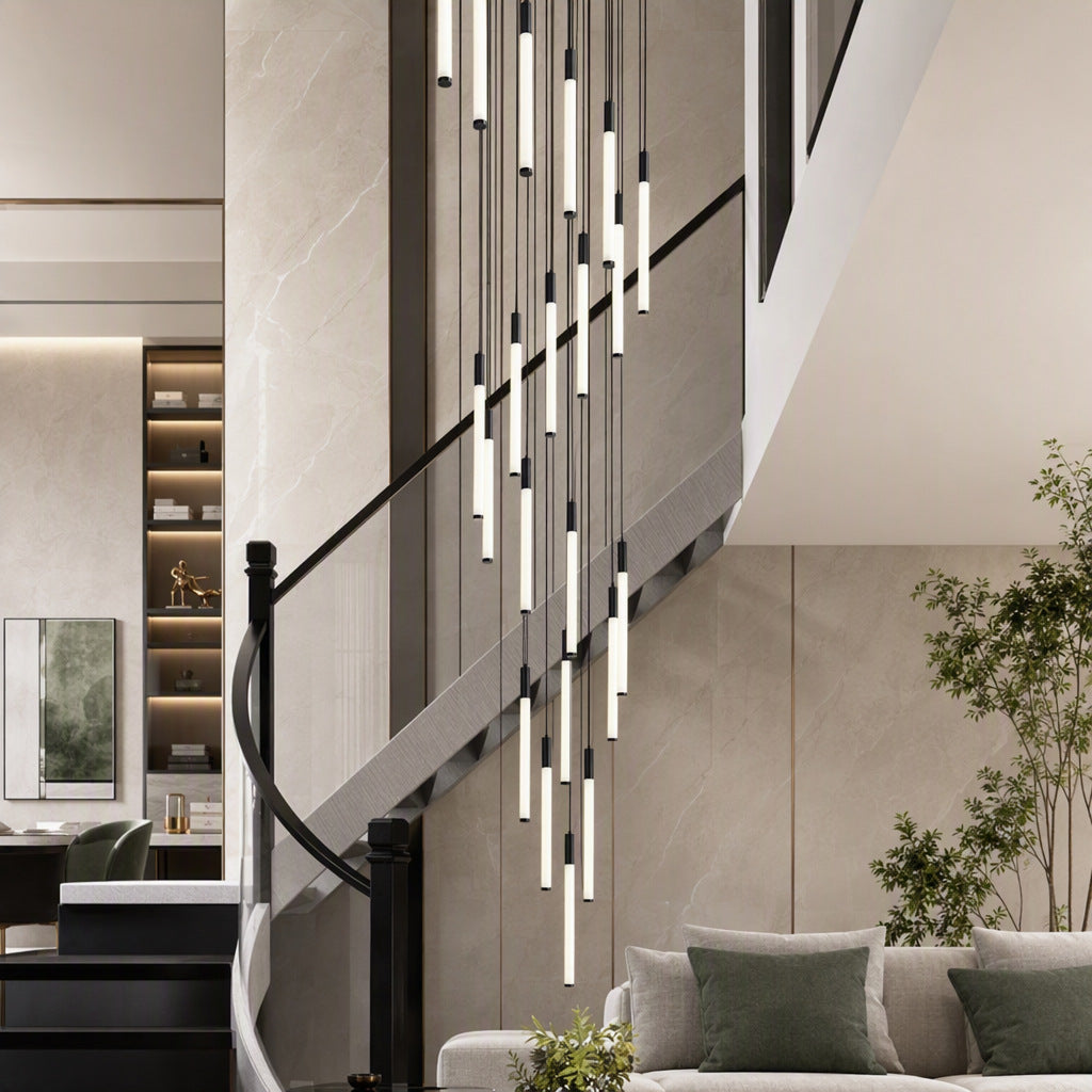 Spiral LED chandelier of slim tube lights hanging above a staircase with a glass balustrade