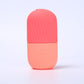 Wine red and pink two tone silicone facial ice tool standing on a light surface